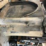 Worn CAT 777 haul truck radiator removed for service at St. Louis industrial repair facility