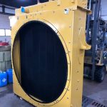 Reconditioned CAT 988 radiator with yellow shroud at St. Louis industrial repair shop