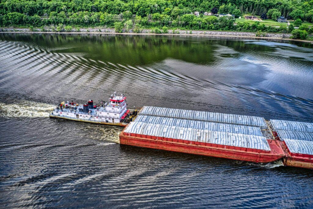 Barge with onboard heat exchanger traveling on river near Paducah, Kentucky